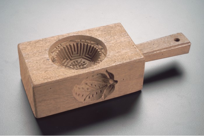<strong><em>Ang ku kueh</em> mould</strong><br>
Early 20th century<br>
Wood<br>
Collection of the Peranakan Museum